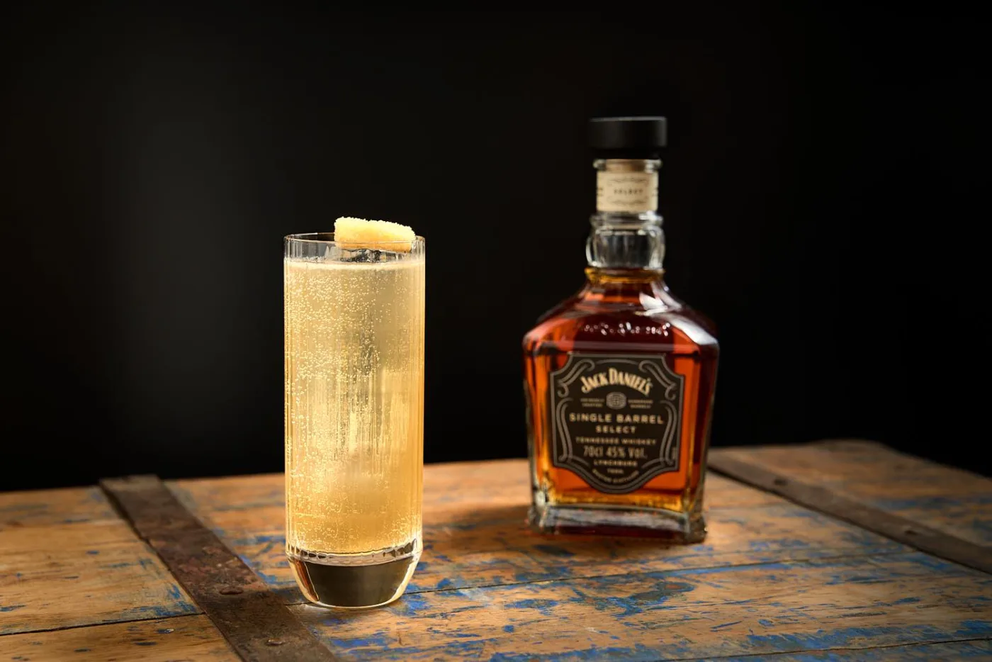 Jack sei un Fico: highball dorato e frizzante con zenzero candito accanto alla bottiglia di Jack Daniel's Single Barrel Select