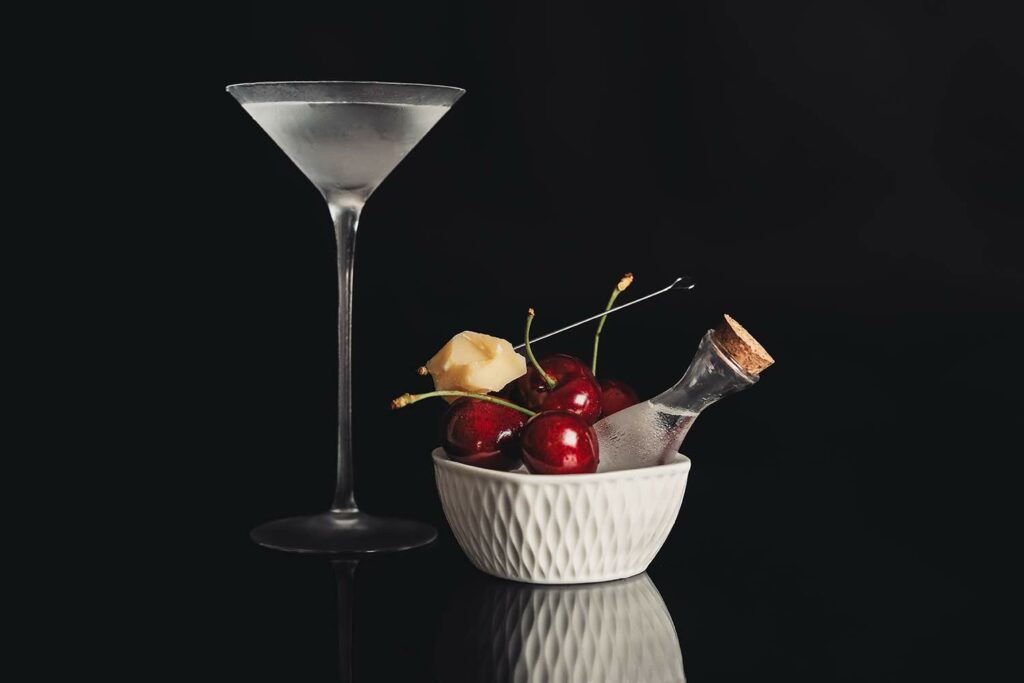 Un Bamboo-tini servito in coppetta e accompagnato con ciliegie e parmigiano